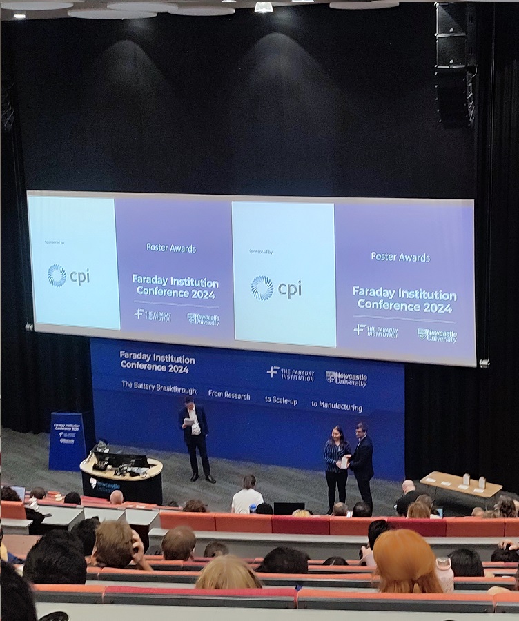 Veronika Šedajová picking up her poster award at the closing of the Faraday Institution conference 2024.